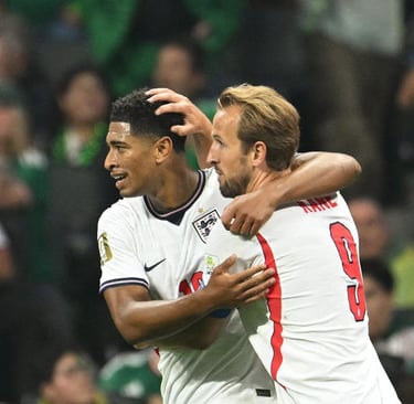 England soccer players Jude Bellingham and Harry Kane celebrate a goal together on the pitch.