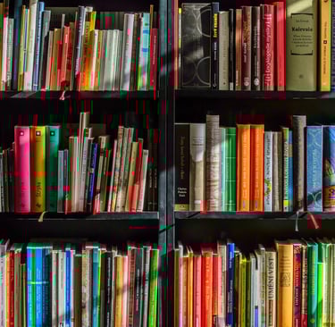 Personal bookshelf filled with books that shaped leadership thinking and perspective