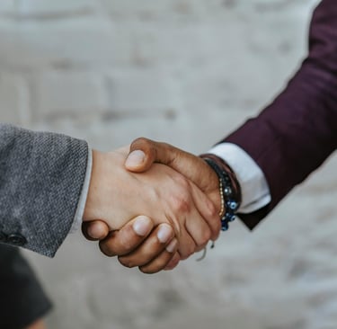 A leader shaking the hand of an employee after a difficult conversation