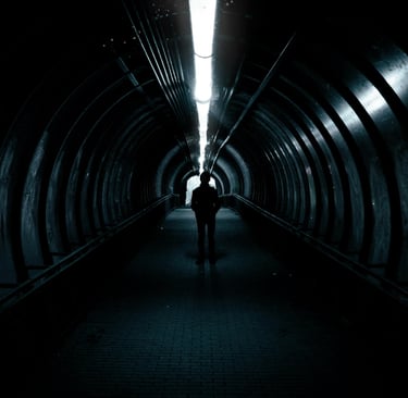 Leader walking through a dark tunnel toward the light, symbolizing early leadership transitions.