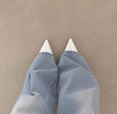 White kitten heels styled with light denim jeans.