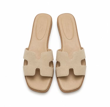 Minimal beige suede slide sandals.