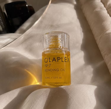 Olaplex No.7 Bonding Oil bottle with luxury neutral aesthetic