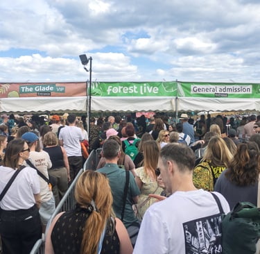 A large crowd of people queuing at the Forest Live general admission and VIP entrance gates.
