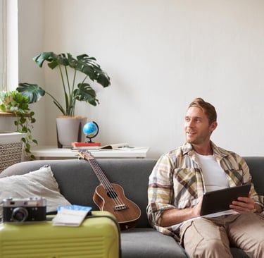 Young British expat working remotely in modern Murcia flat reviewing home insurance policy on tablet