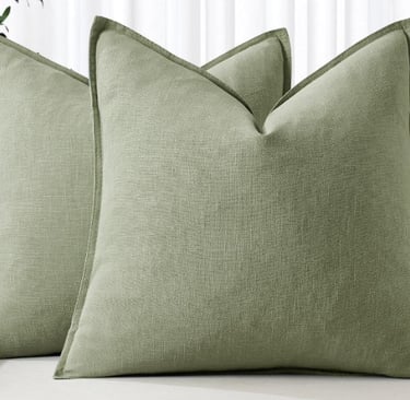 Pair of sage green linen decorative throw pillows with flanged edges.