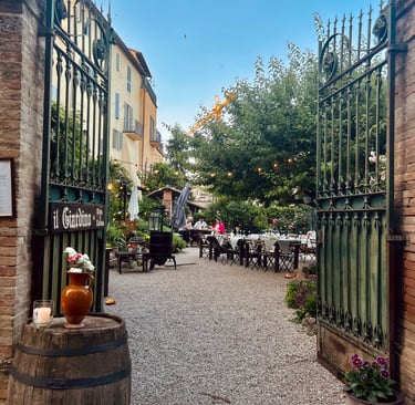 San Gemini, Il giardino - Vino e cucina - a gated in area with a barrel of wine