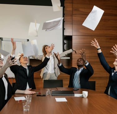 Diverse team celebrating FICA tax savings and employee benefits in a modern office environment