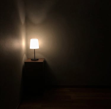 Poor lighting room with single dim light creating dull atmosphere.