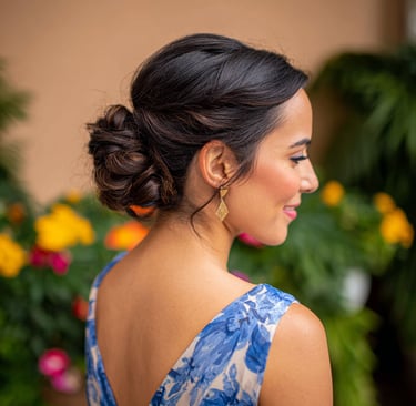 Elegant low bun wedding guest hairstyle with soft tendrils