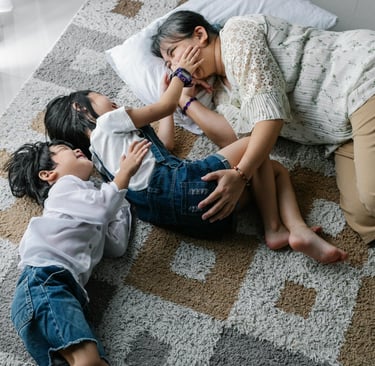 a mom and two children playing together