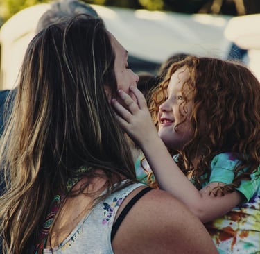 a moher holding and hugging her child