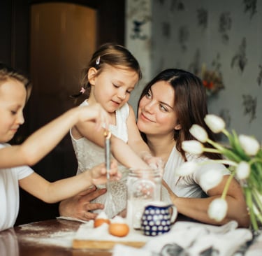 a mother and two children baking or cooking together