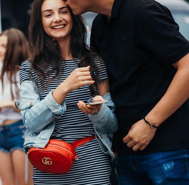a husband and wife kissing in the street