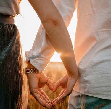 a couple holding hands in a wheat field