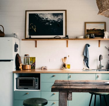 a kitchen with a table and stools