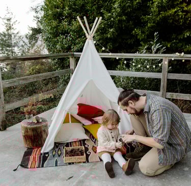 dad playing make believe house with his daughter