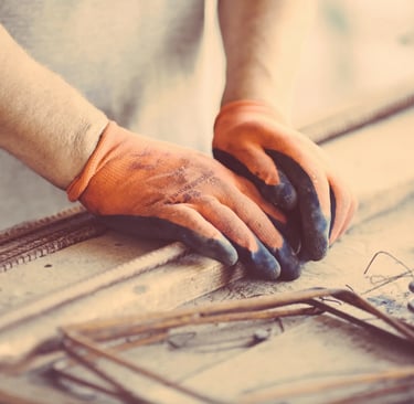 iron work for handy man with orange gloves on