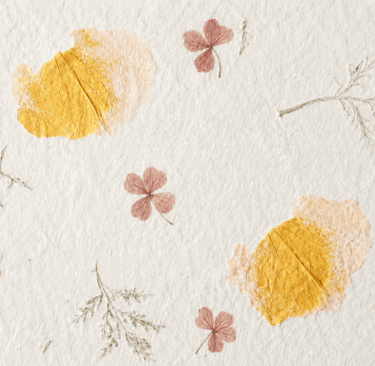 Handmade paper texture with pressed dried flowers and botanical leaves for scrapbooking.