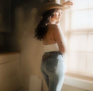 a woman in a white top and jeans 