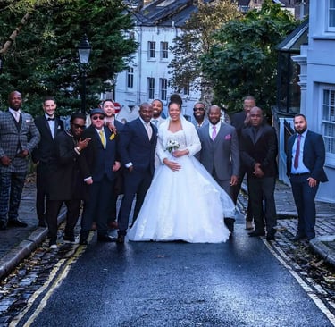 newly-weds posing on a Hampstead street with their wedding guests