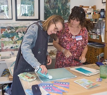 Image of two artists painting