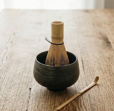 bamboo matcha whisk (chasen) inside ceramic bowl on wooden surface