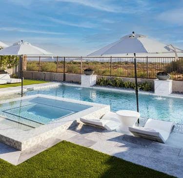 Geometric pool with crystal blue water, white marble-look tiles and an elevated spa ledge