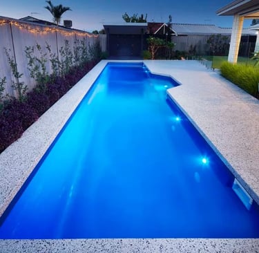 Contemporary lap pool with vivid blue water, smooth interior finish and light aggregate tiling