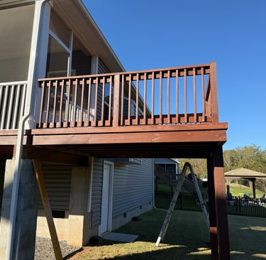 Freshly stained deck on the back of a house.