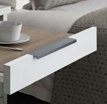 Sleek grey flush cabinet handle installed on a white furniture drawer – minimalist hardware for kitchen, bedroom