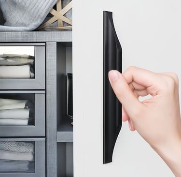 Black modern cabinet door pull handle: hand gripping the sleek black hardware on a wardrobe with fabric storage drawers