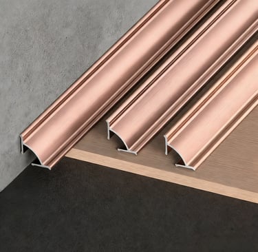 Copper-colored metal floor transition strips: decorative trim for connecting concrete, wood, and tile flooring surfaces