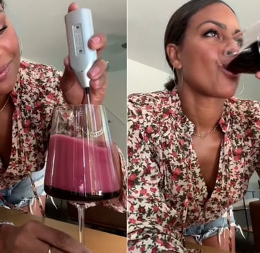 a woman drinking a glass of wine in a wine glass