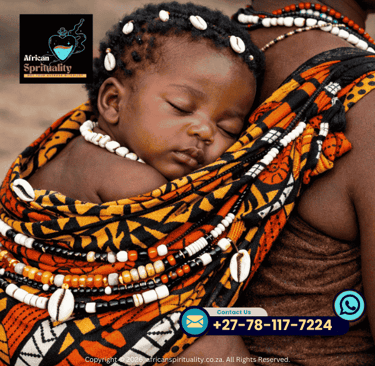 An African baby sleeping in a traditional patterned baby carrier with cowrie shell jewelry and beads.