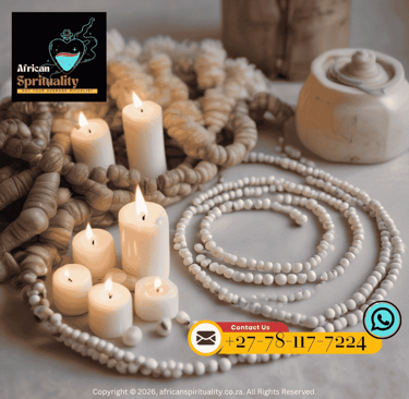 White candles and traditional African prayer beads arranged for a spiritual ritual.