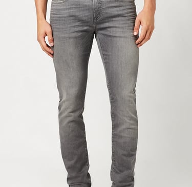 a man in a gray shirt and  gray jeans 