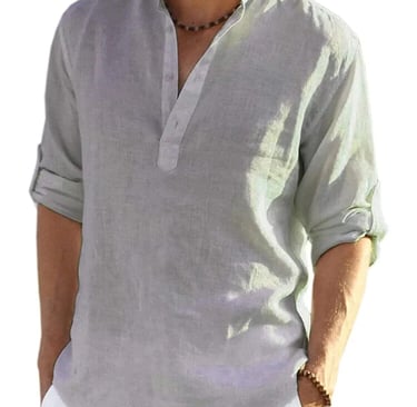 a man in a grey shirt and white pants