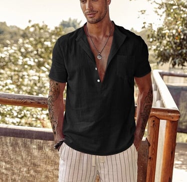 a man in a black beach style shirt and white shorts