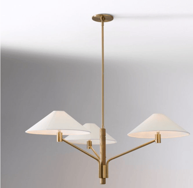 Modern brass and wood chandelier featuring three white tapered shades for elegant dining room lighting.
