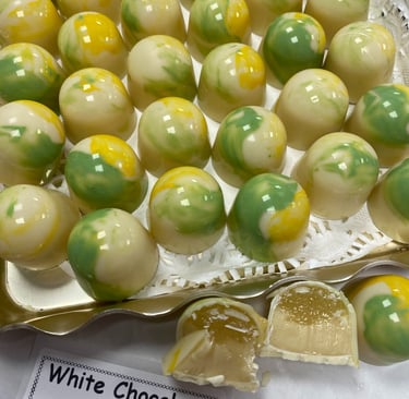 Pina colada . a layed of pina colada pate de fruit jelly with a white chocolate coconut ganache