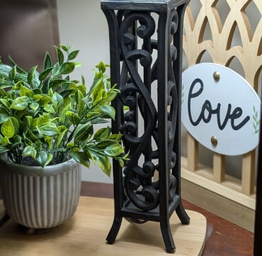 a stand in my home with plant, soft lamp light, & love decor