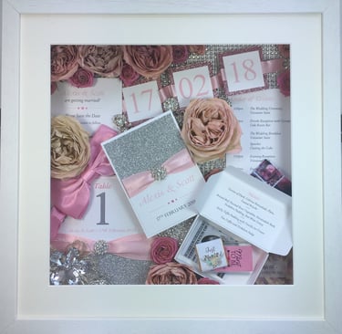 memory box full of wedding items, table numbers, preserved wedding bouquet flowers and diamantés