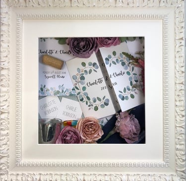 memory box of wedding invitations, wine cork and preserved wedding bouquet flowers