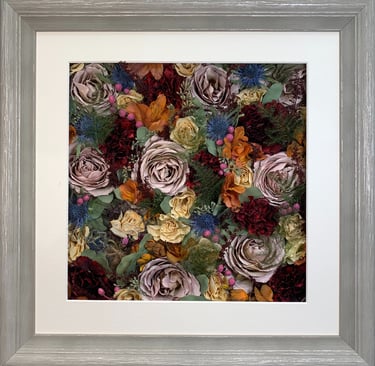 a flower wall style preserved wedding bouquet in a washed white frame