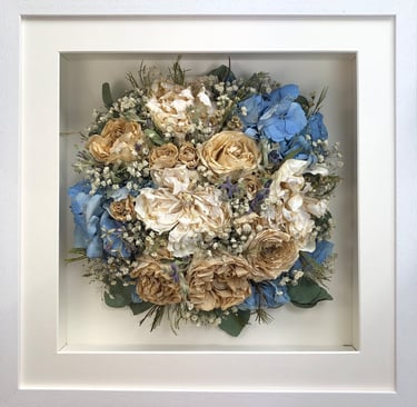 Birdseye view preserved wedding bouquet with soft ivory and blues in a frame