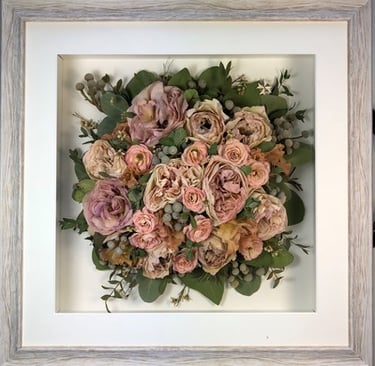 Birdseye view preserved wedding bouquet in a frame with soft peaches and pinks
