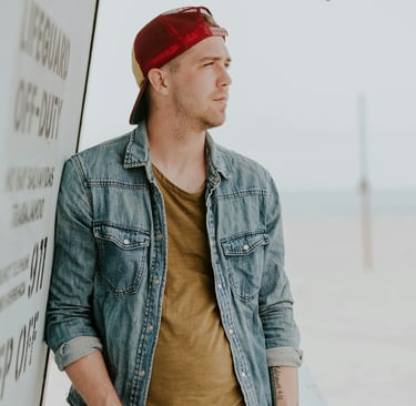 a man in a denim jacket and a red bandanna