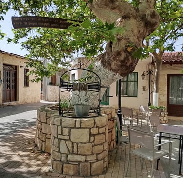 Alagni Village square with a Platanus tree, an old well, and a drinking water spring