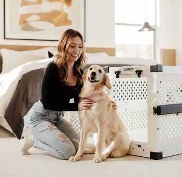 woman with golden retriever in modern bedroom